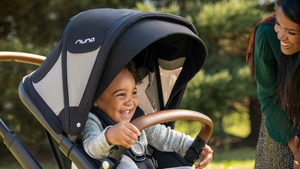 Close Up of A Happy Baby Sitting in A Nuna Demi Grow