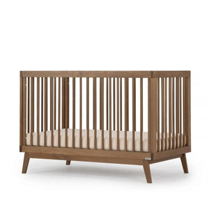 dadada Soho 3-in-1 Convertible Crib in Walnut Wood - 45-Degree Side Angle View | Strolleria